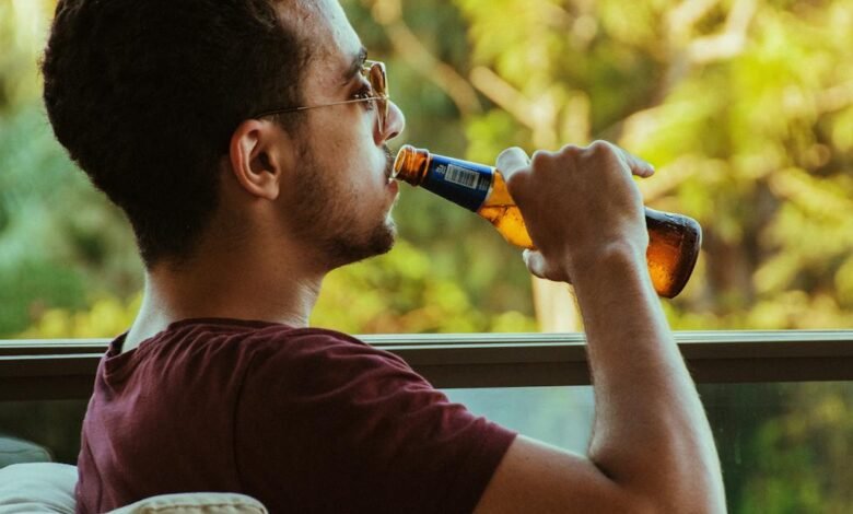 man sitting and drinking beer