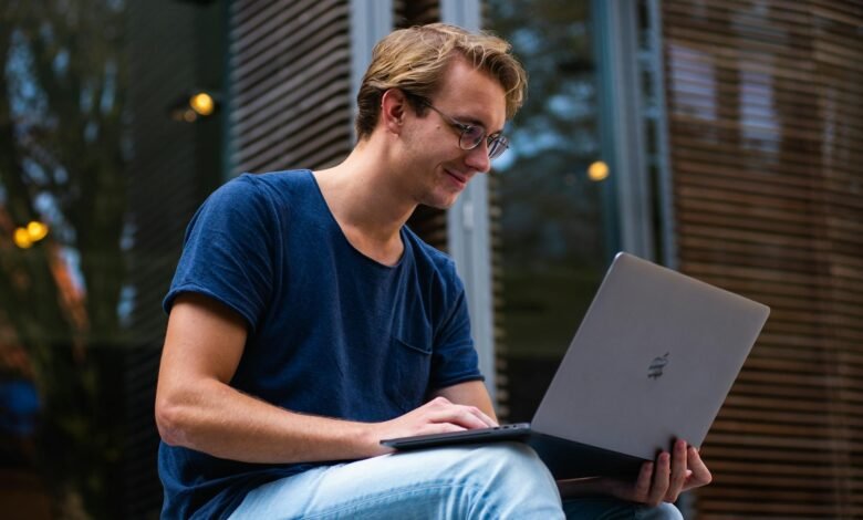 selective focus photo of man using laptop