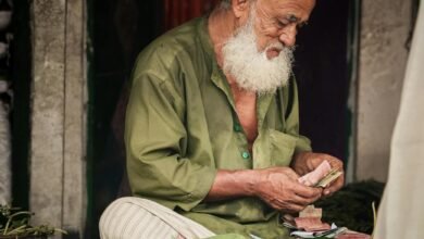 elderly vendor selling betel leaves at market