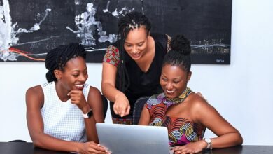 three women looking at the computer
