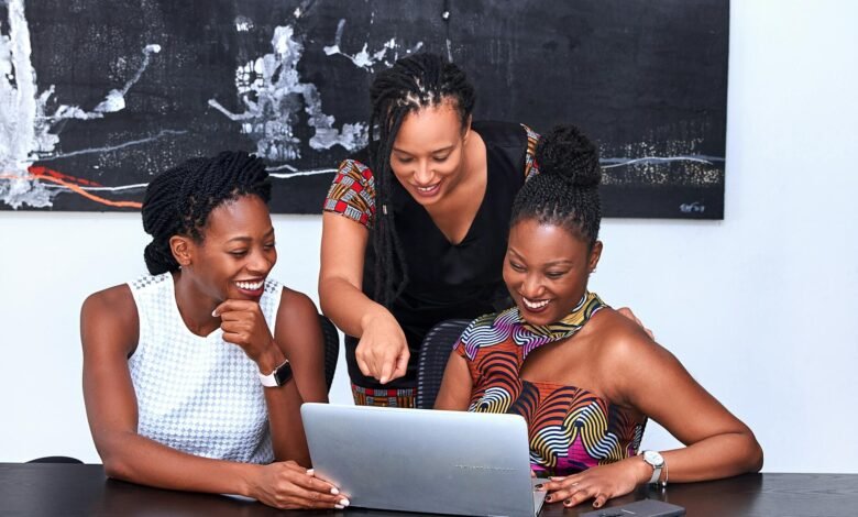 three women looking at the computer