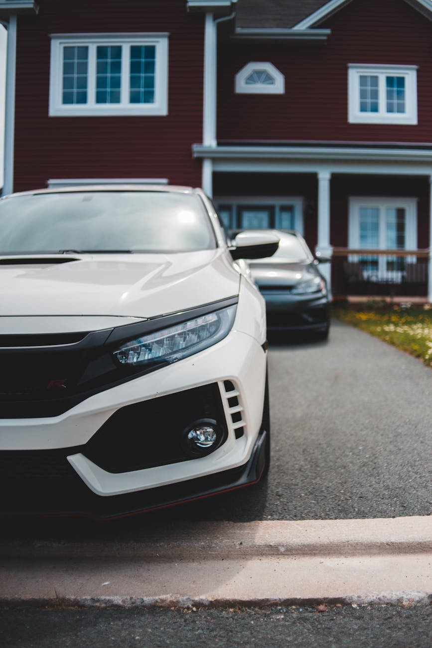 luxury vehicle parked next to cottage