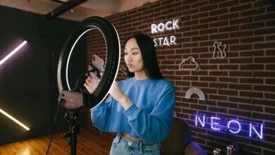 a woman using her phone while attached on a ring light