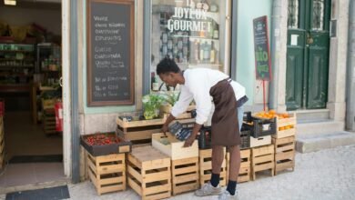 a man fixing trays outside a store