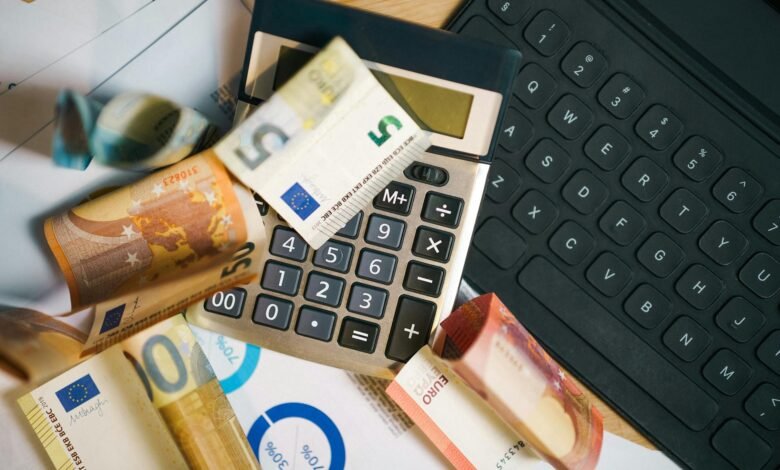 euro banknotes with calculator and laptop keyboard