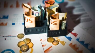 euro banknotes and coins on financial charts