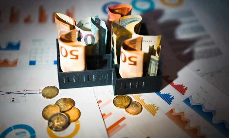 euro banknotes and coins on financial charts