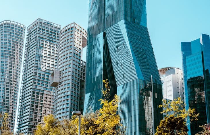 modern skyscrapers and park in sunny cityscape