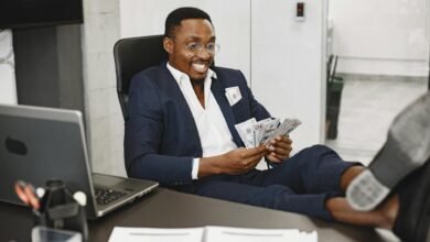 happy elegant man with money in office