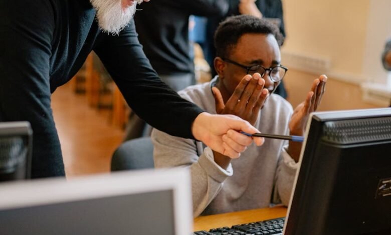 an elderly man pointing something on a computer screen