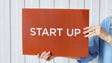 person holding a paper with start up sign