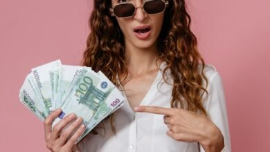 a woman in white long sleeves holding money