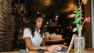 woman working on laptop in bar