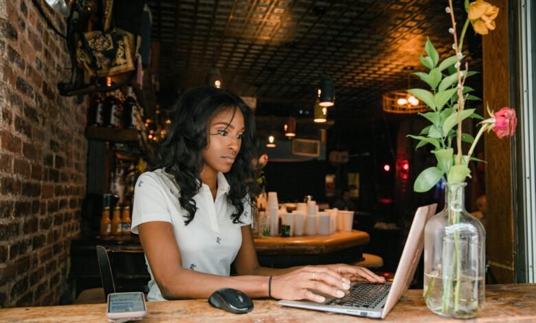 woman working on laptop in bar