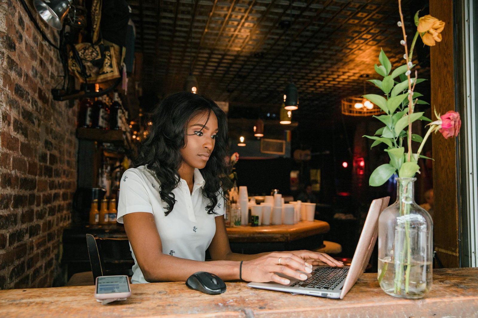 woman working on laptop in bar