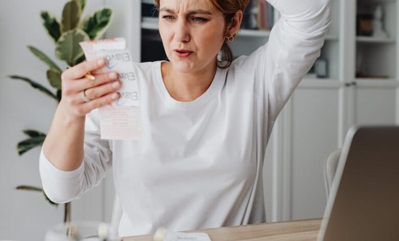 woman looking at a receipt and making a surprised face