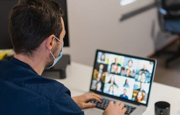 a man having a video call on his laptop