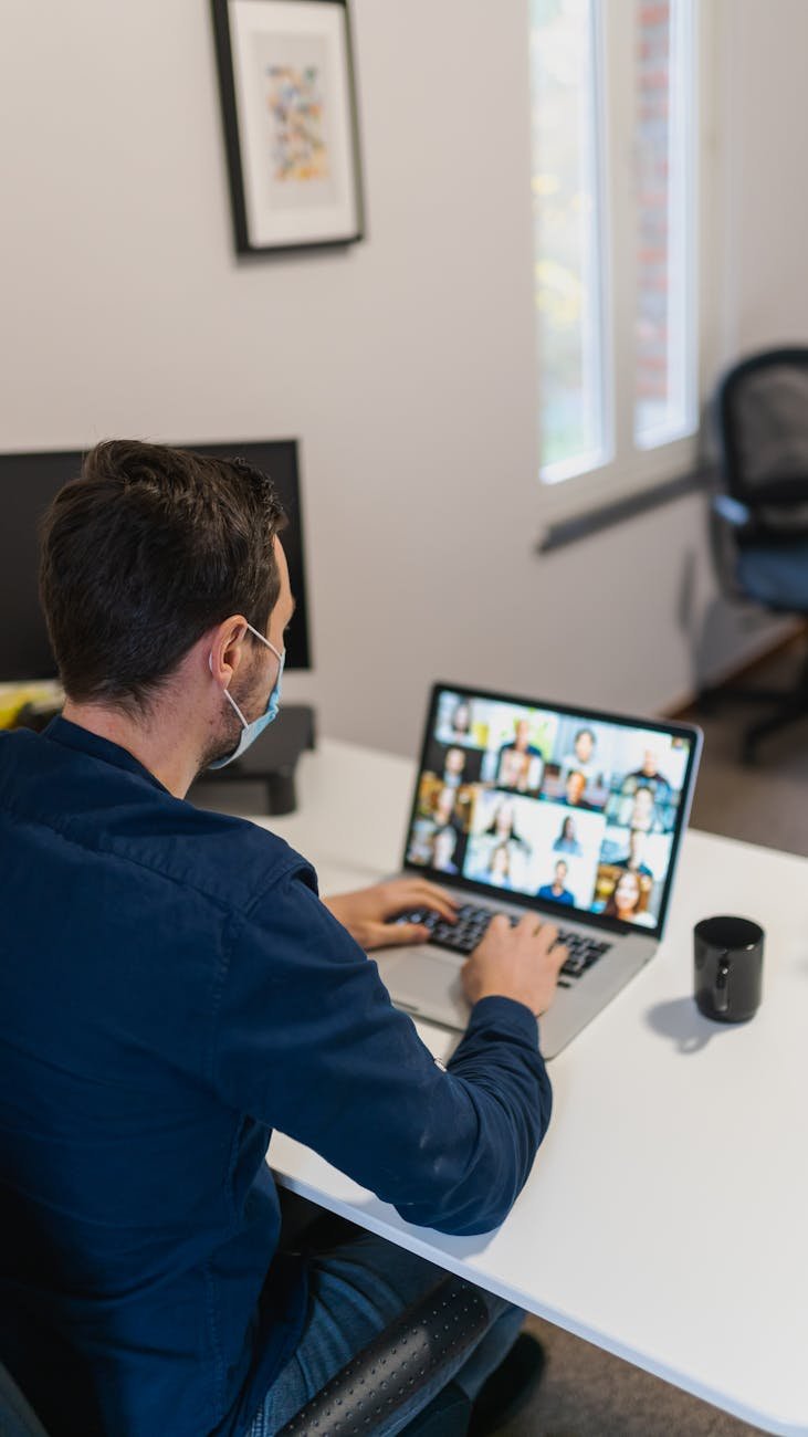 a man having a video call on his laptop