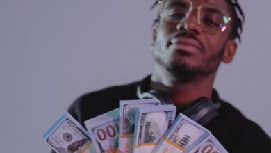 a man holding bundles of money