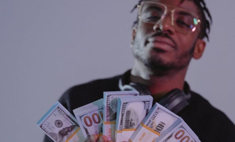 a man holding bundles of money