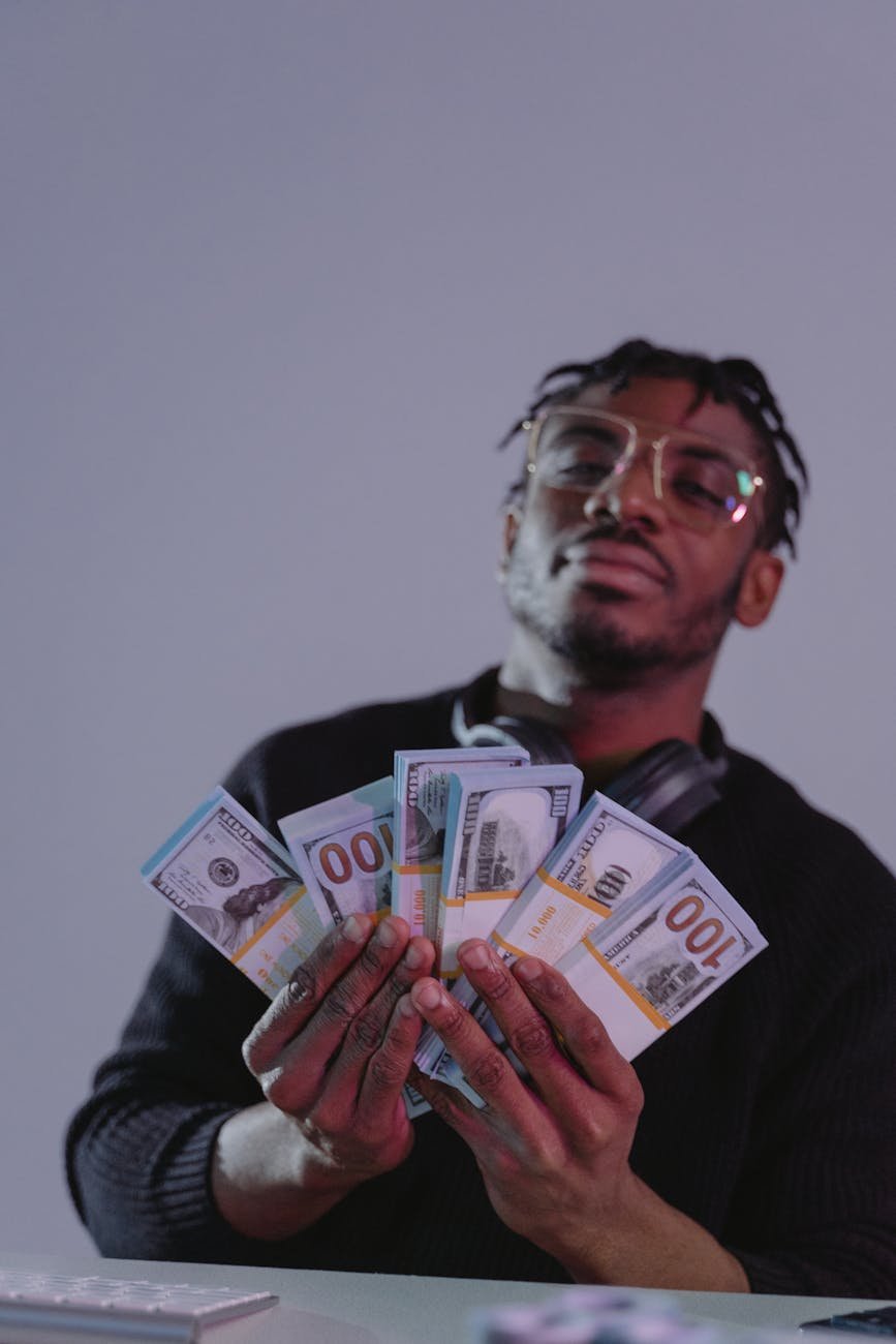 a man holding bundles of money