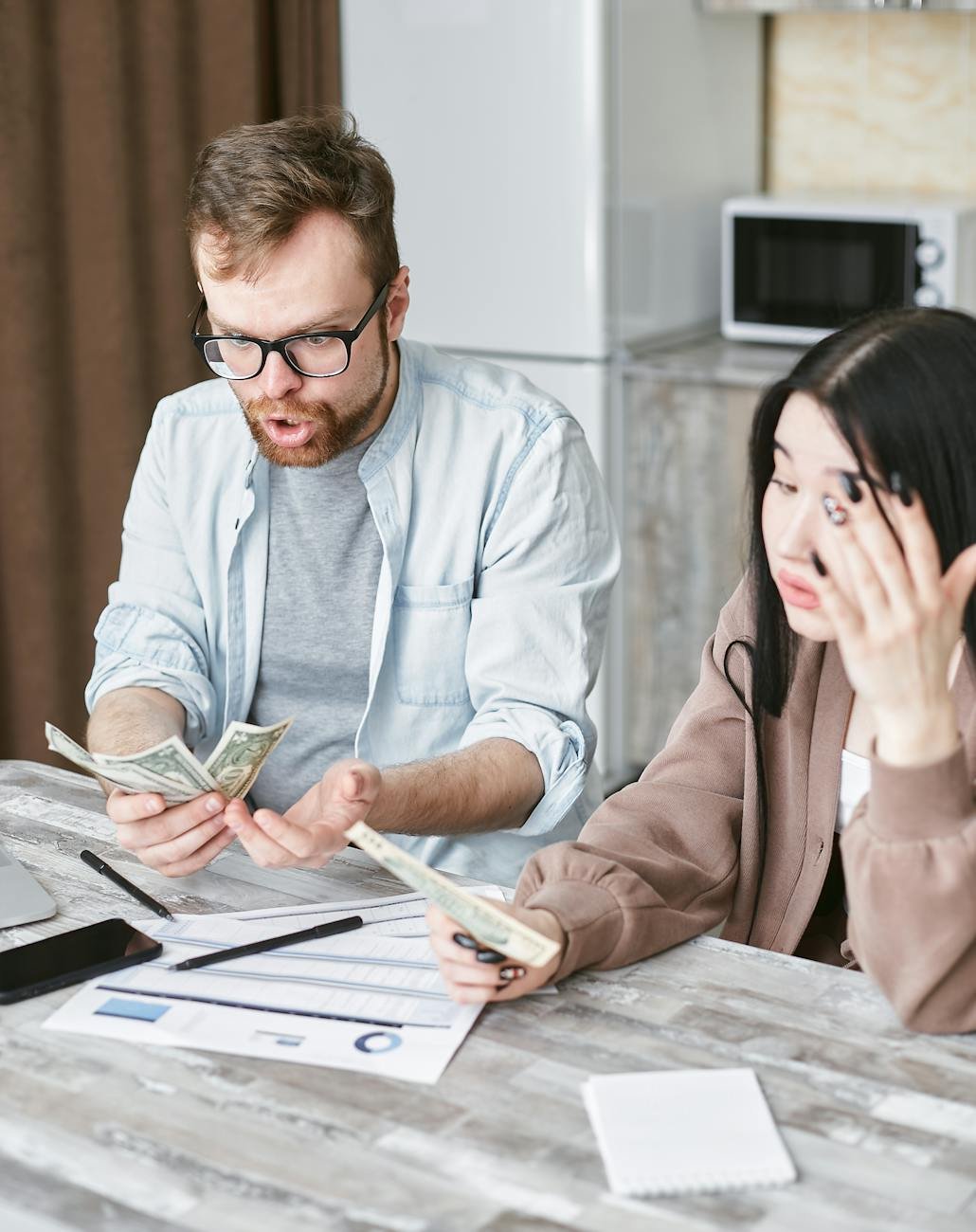 man and woman holding a money