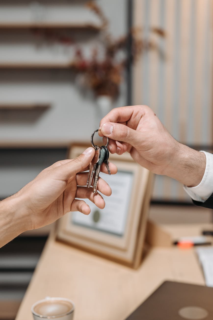 a person giving keys to another person