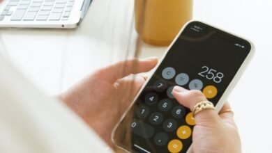 a person calculating on her cellphone