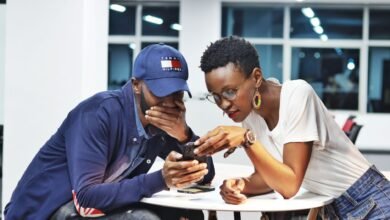 man and woman looking at smartphone