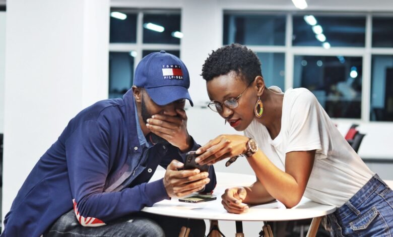 man and woman looking at smartphone