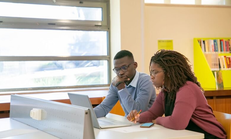black couple doing presentation for studies in classroom