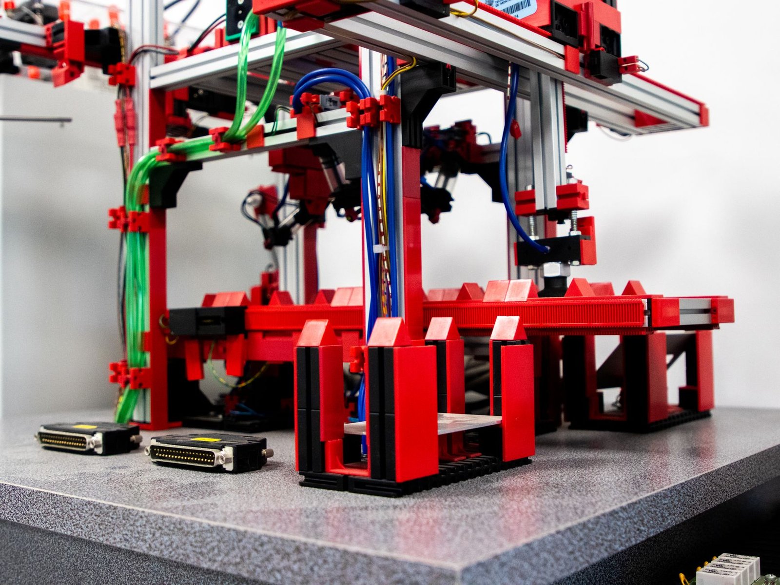 a red and black machine with wires and wires