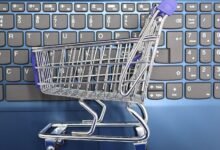 mini shopping cart on laptop keyboard e commerce concept