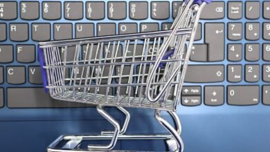 mini shopping cart on laptop keyboard e commerce concept