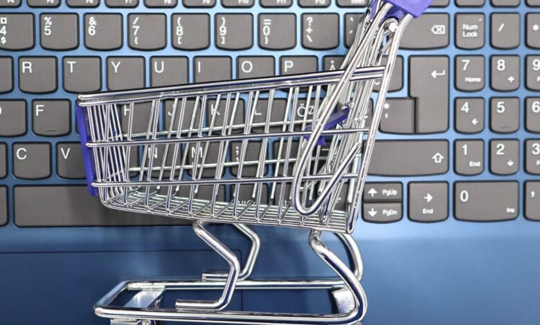 mini shopping cart on laptop keyboard e commerce concept