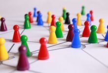 close up photography of yellow green red and brown plastic cones on white lined surface